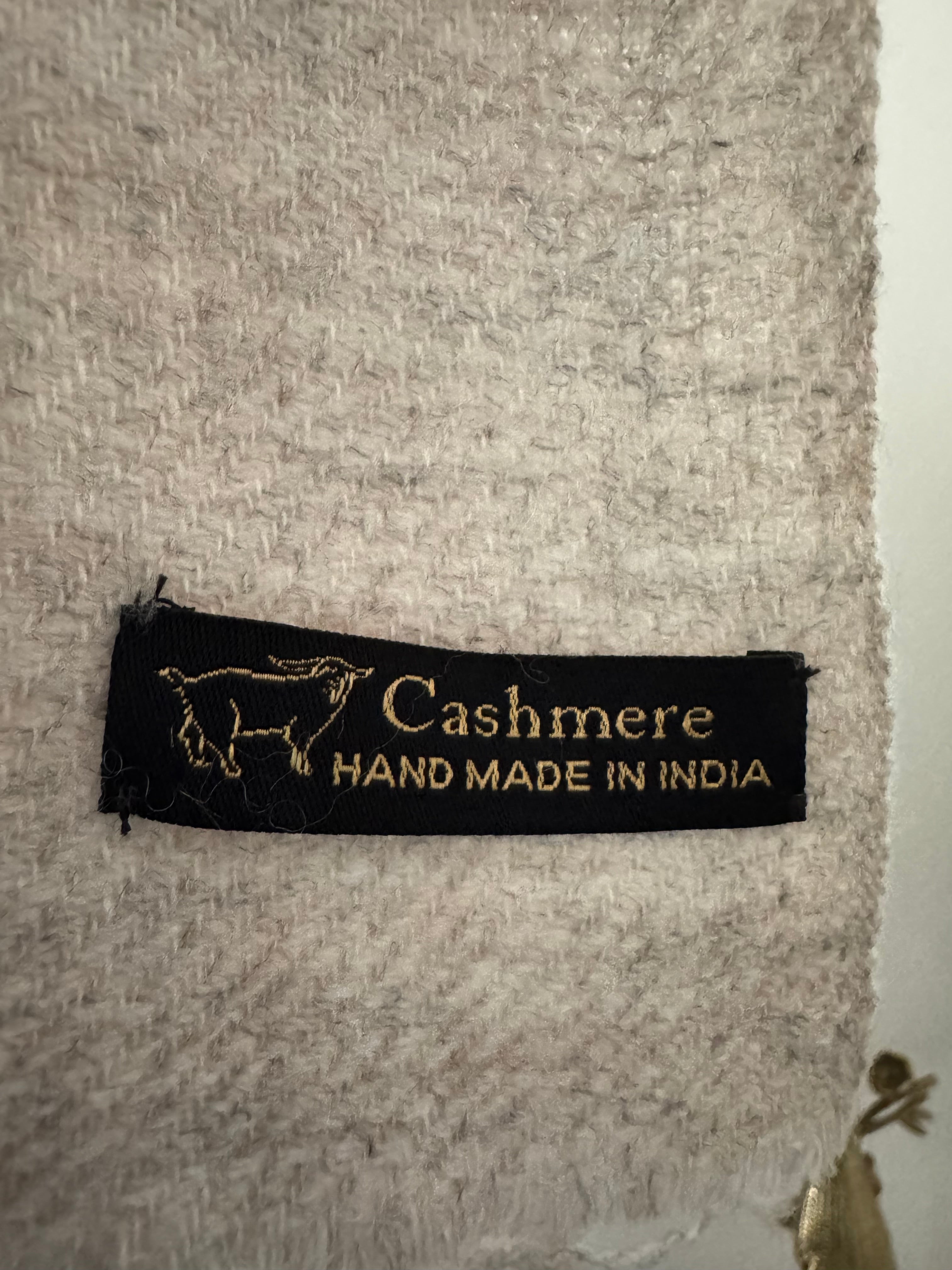 Cashmere fabric with a label indicating 'Hand Made in India'.