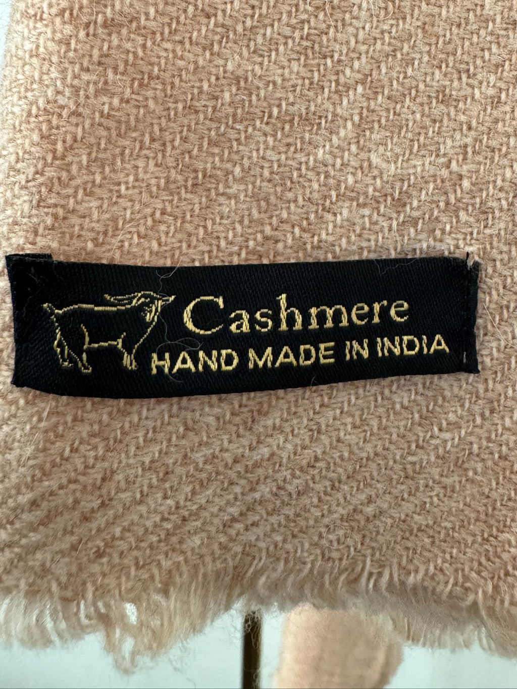 Cashmere label on a textured fabric background
