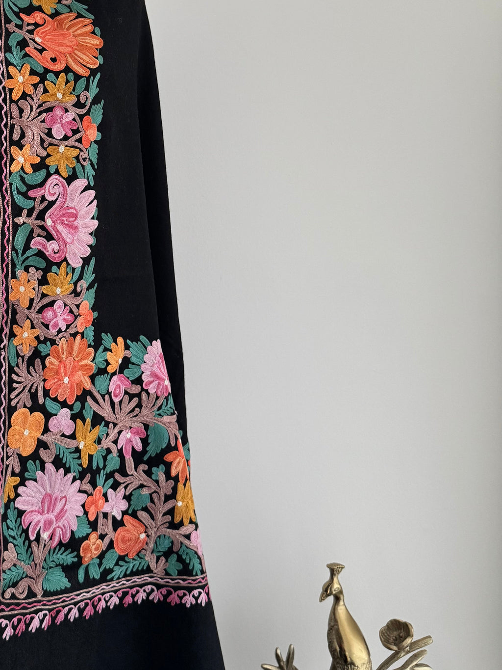 Decorative shawl with floral embroidery on a white background