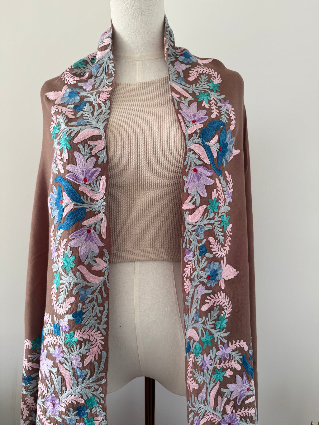 Floral-patterned fabric strip on a mannequin with a plain background