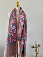 Floral embroidered scarf on a mannequin with a plain background