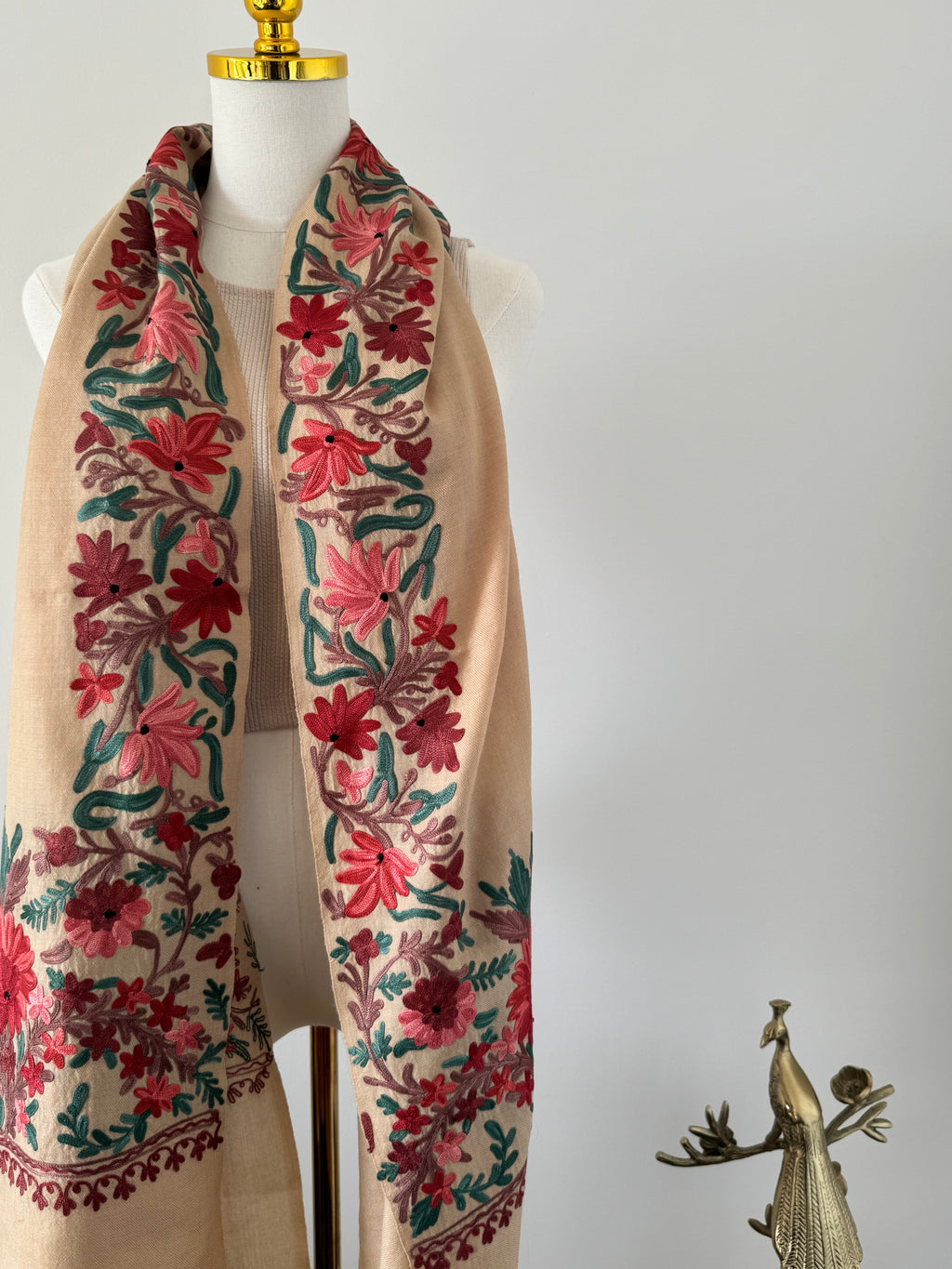Decorative fabric with floral patterns on a mannequin against a white background