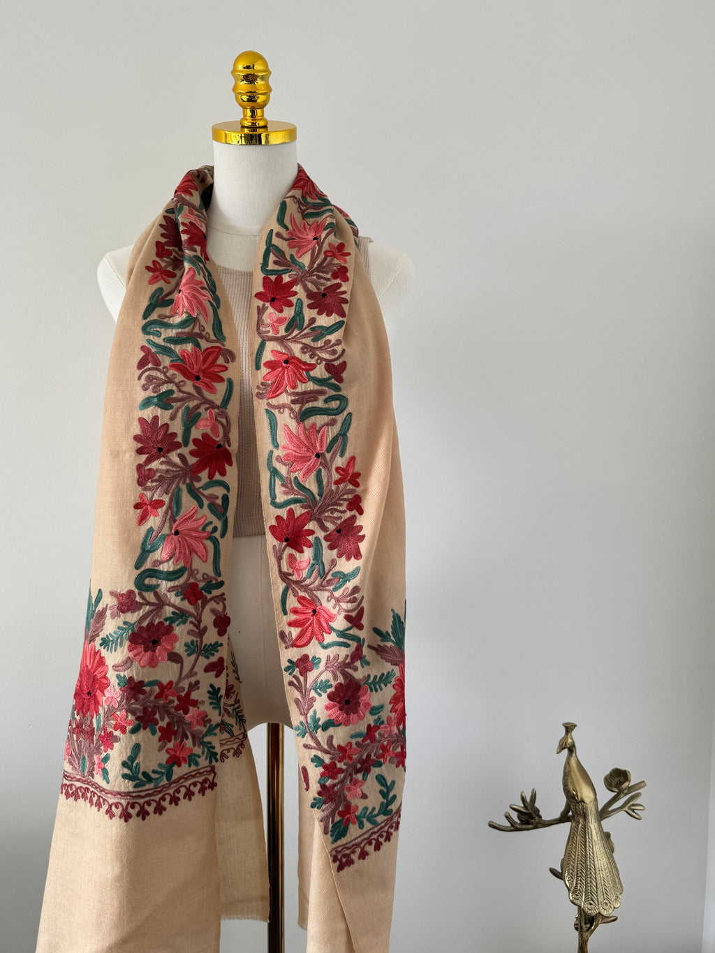 Fabric with floral patterns on a mannequin against a white background