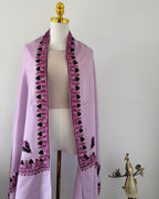 Purple shawl with black embroidery on a mannequin against a white background