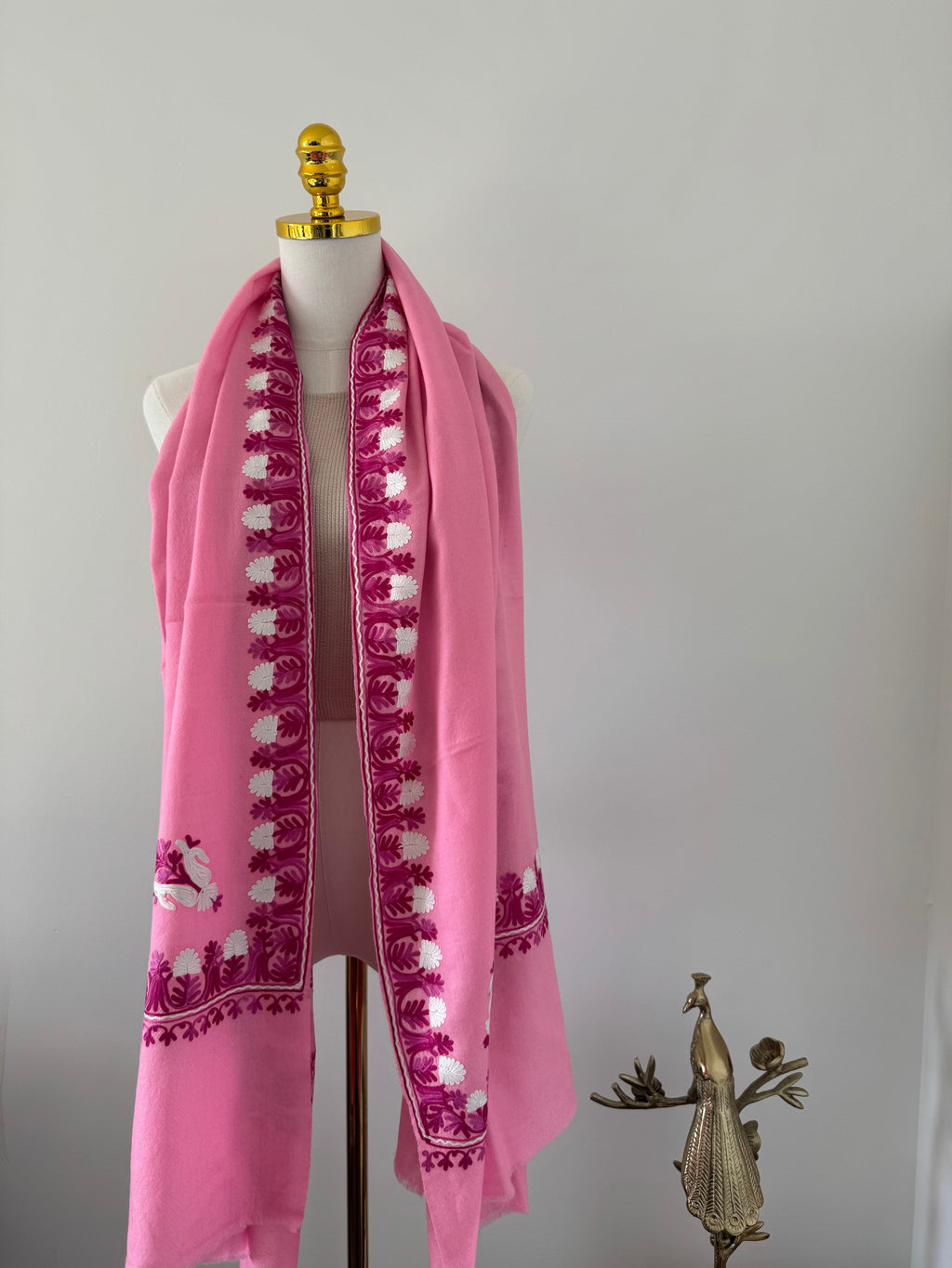 Pink shawl decorative design on a white background