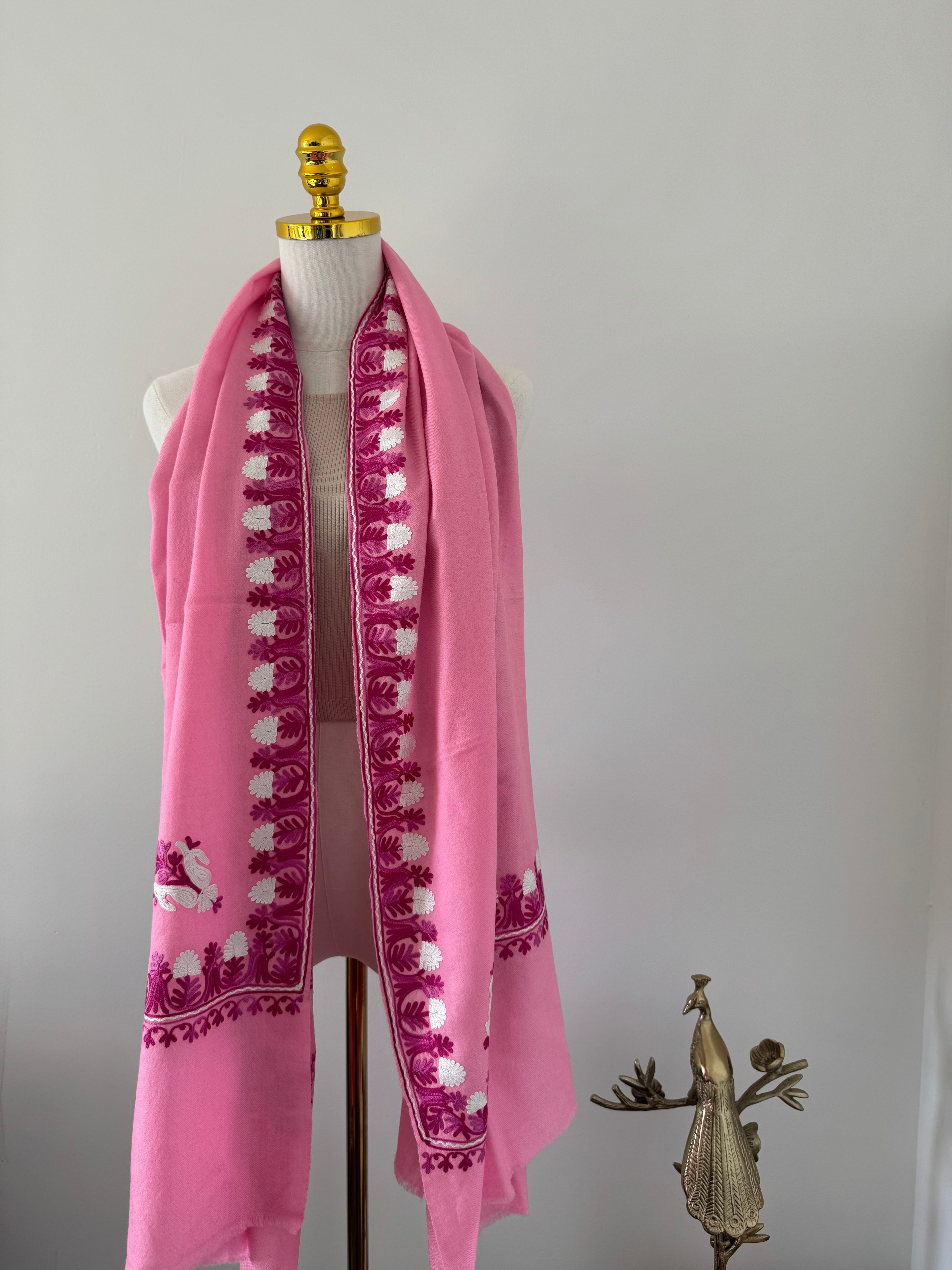 Pink shawl decorative design on a white background