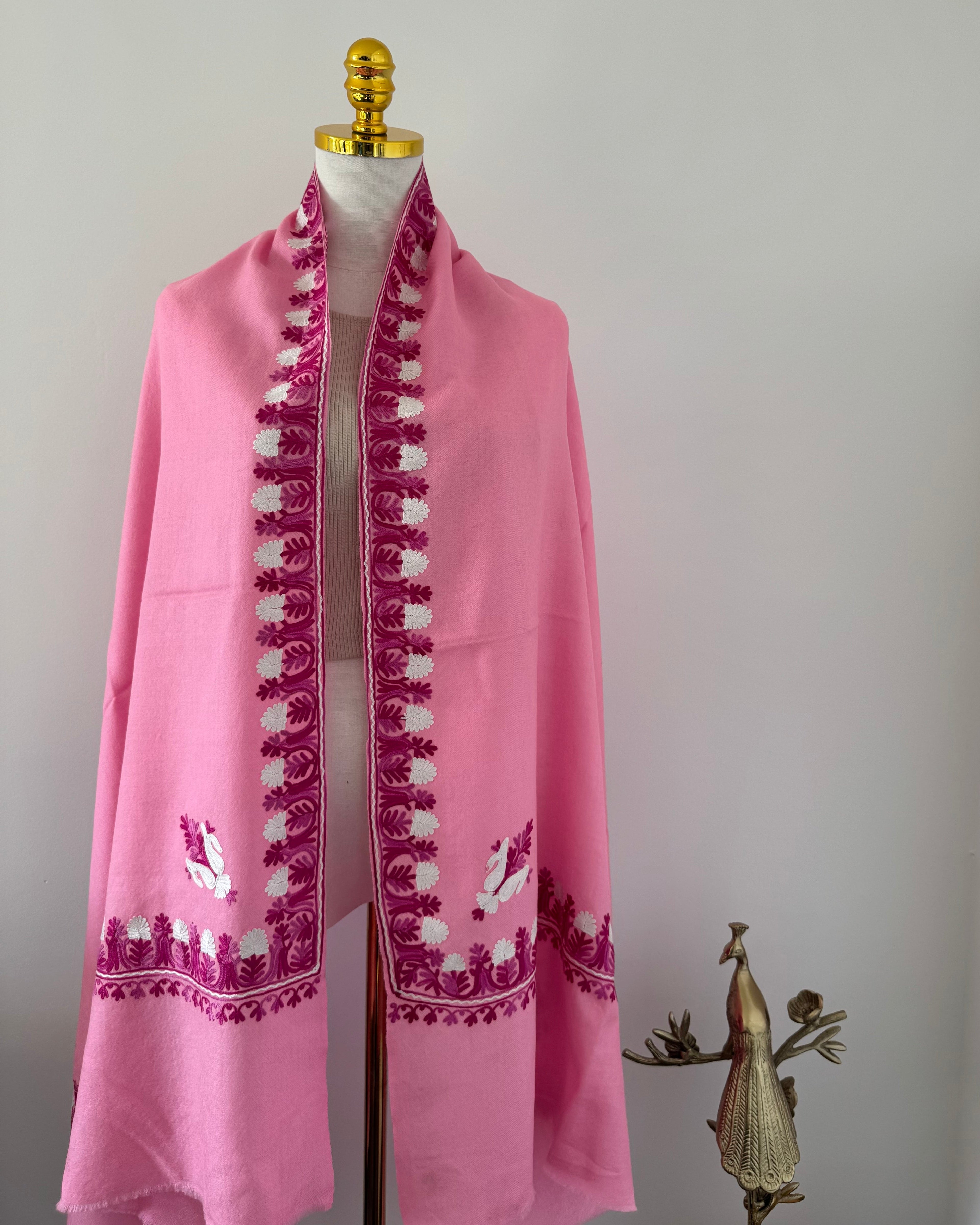 Pink shawl with embroidery on a white background