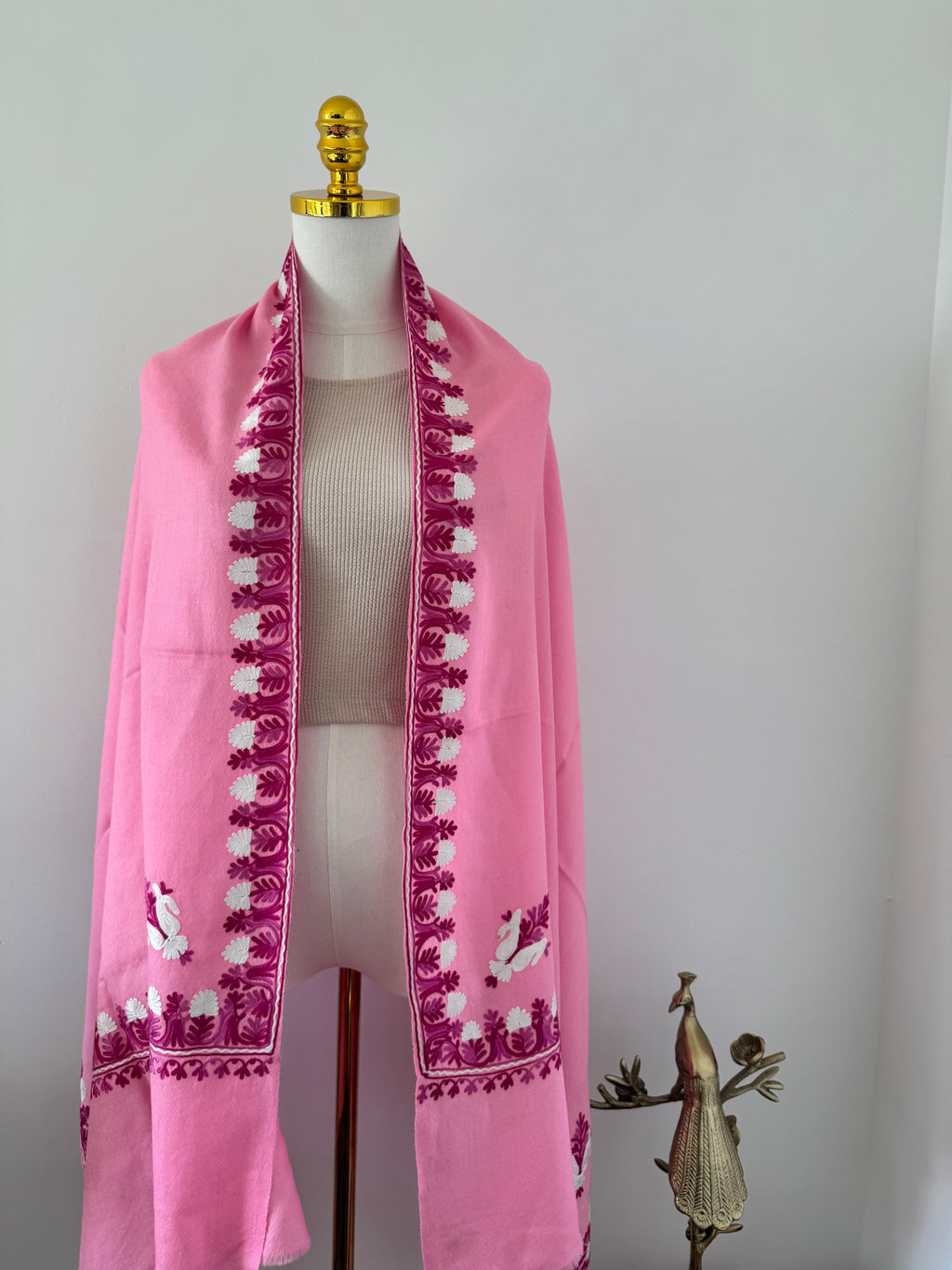 Decorative pink shawl on a white background