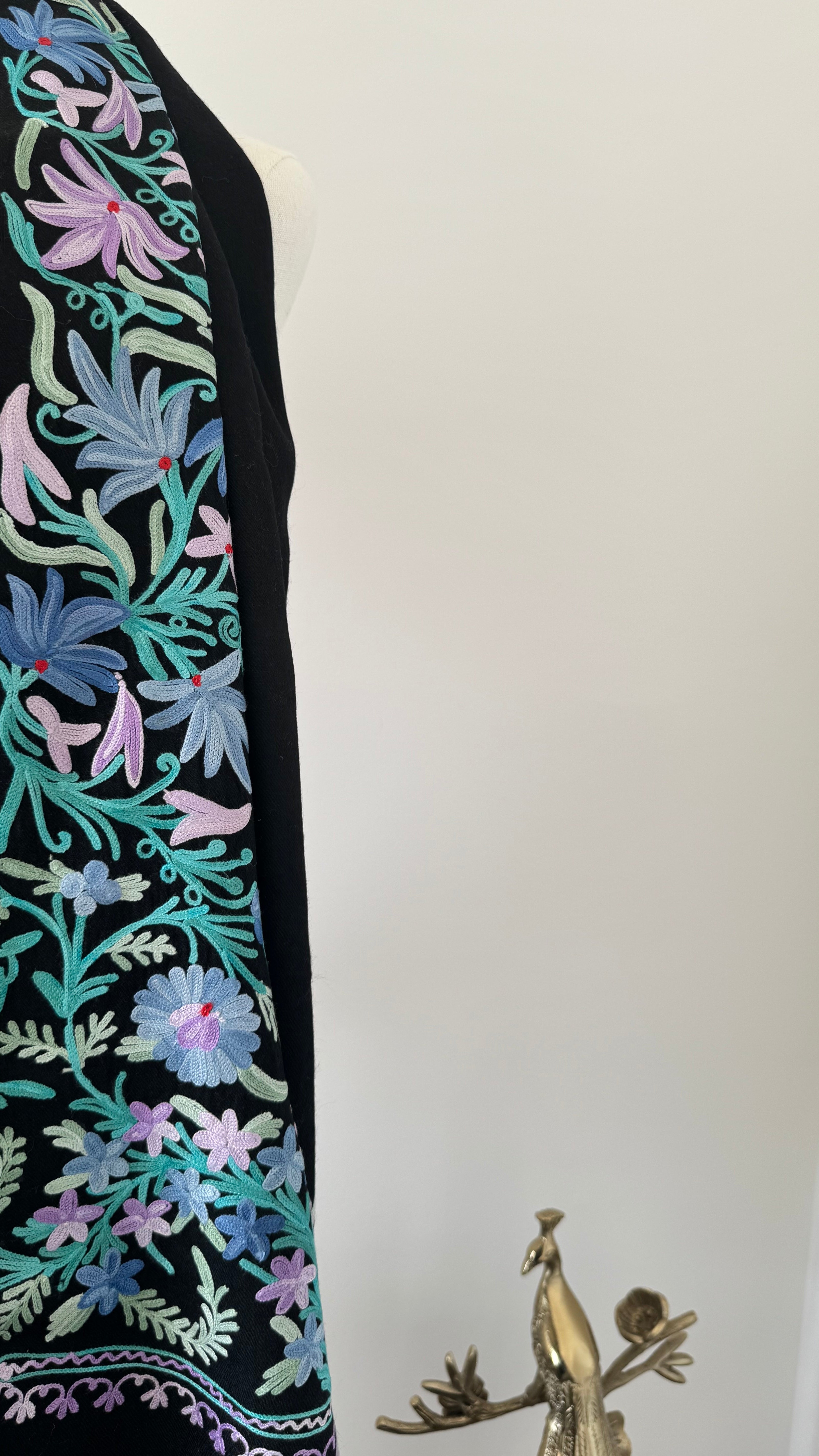 Embroidered fabric with floral patterns on a plain background