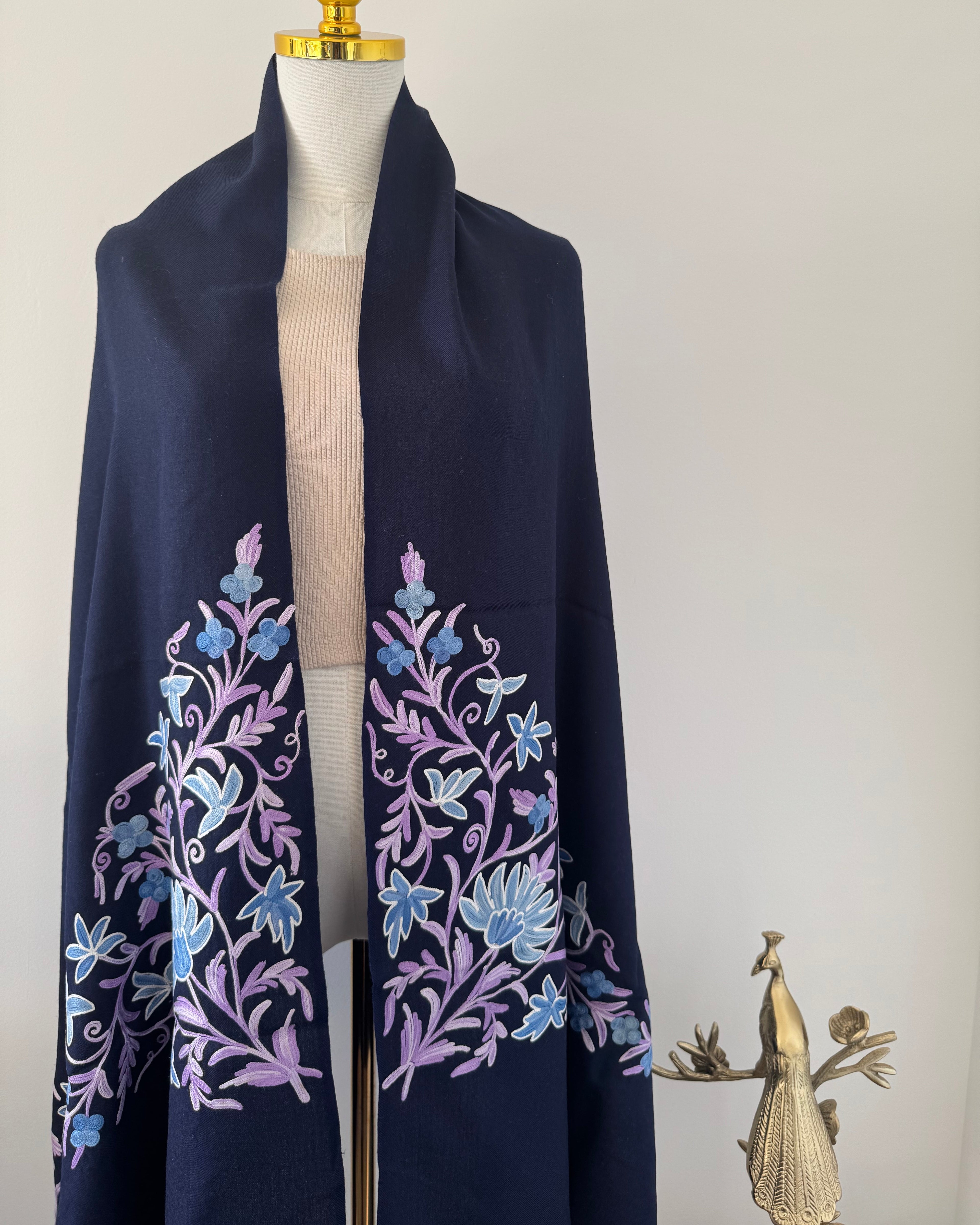 Navy blue fabric with floral embroidery on a white background