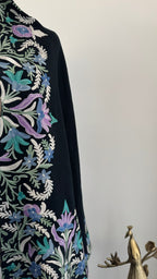 Decorative shawl with floral patterns on a plain background