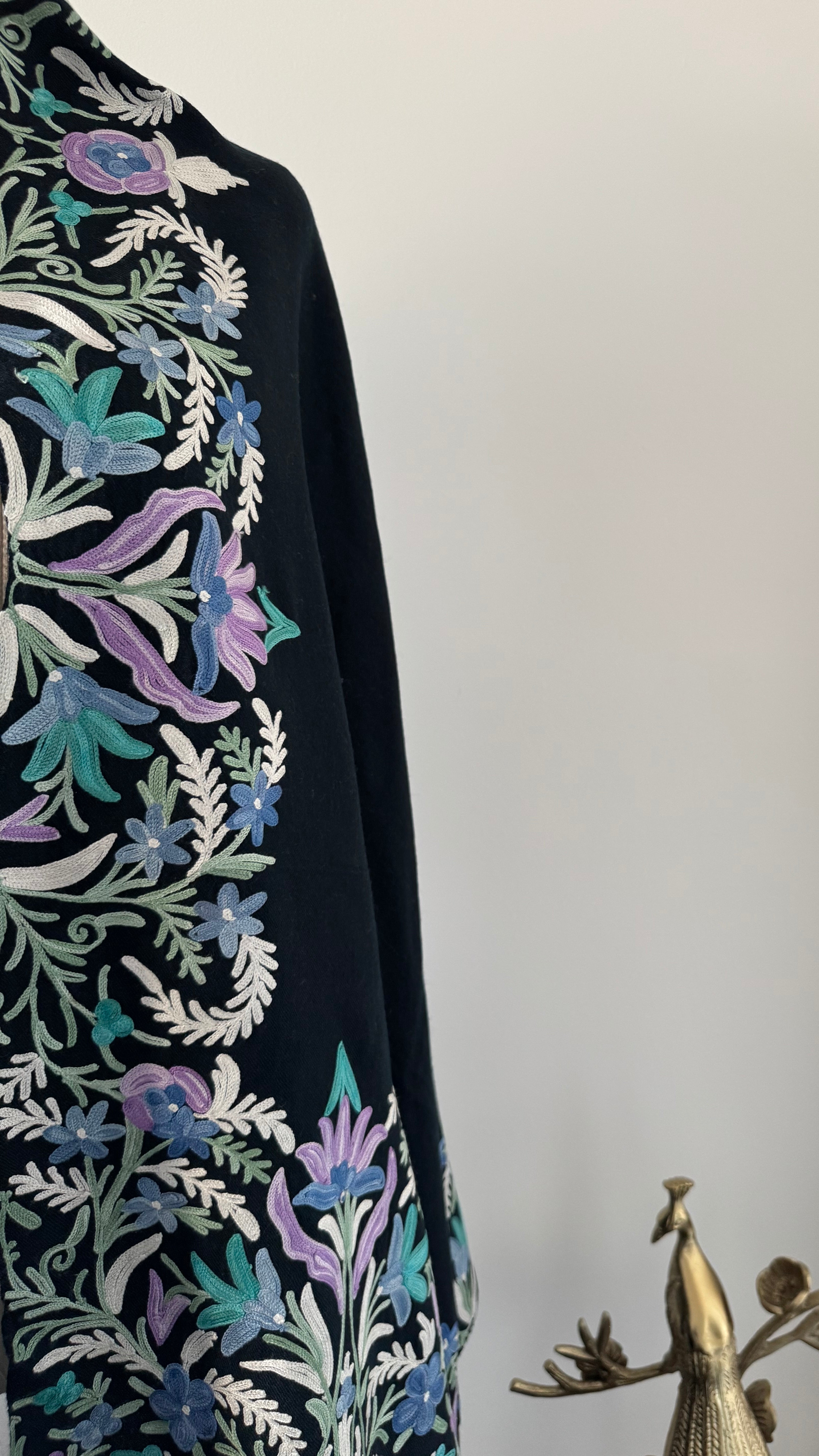 Decorative shawl with floral patterns on a plain background