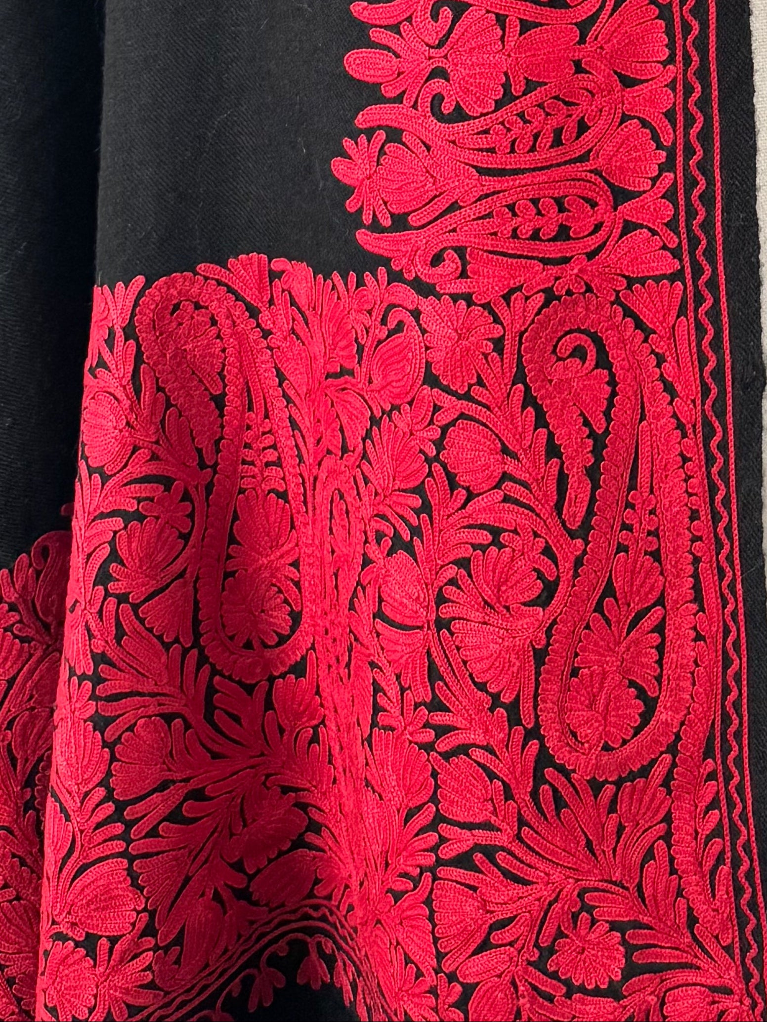 Close-up of red embroidered fabric on a black background