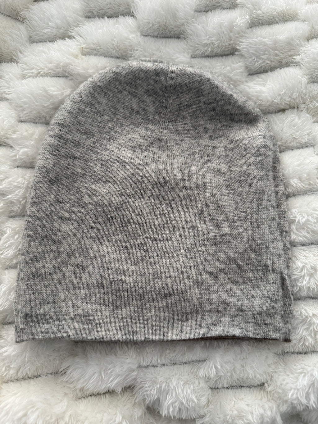 Gray textured fabric sample on a white textured surface