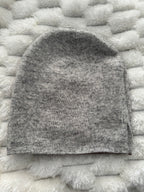 Gray textured fabric sample on a white textured surface