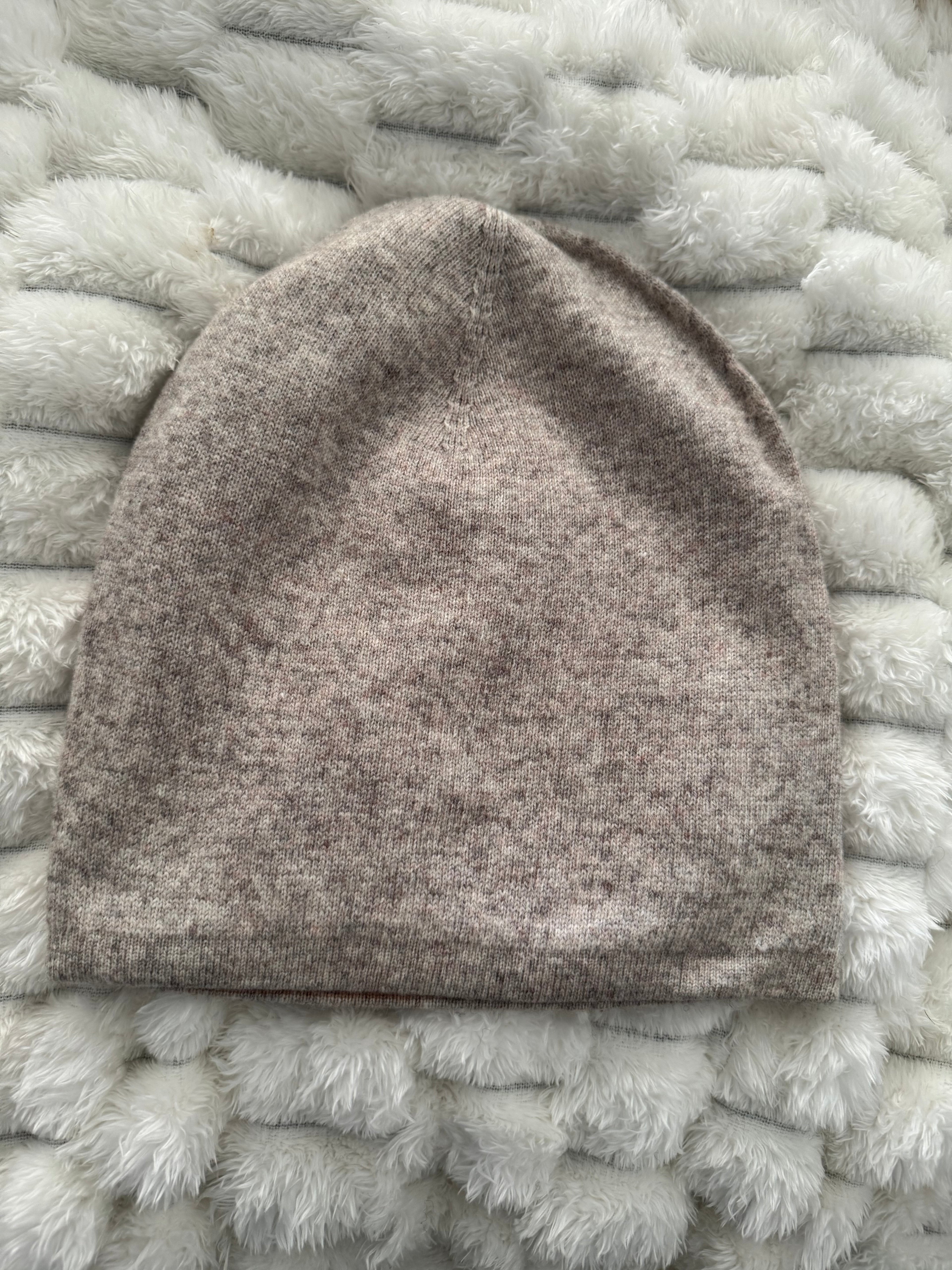 Brown knitted blanket on a textured white surface