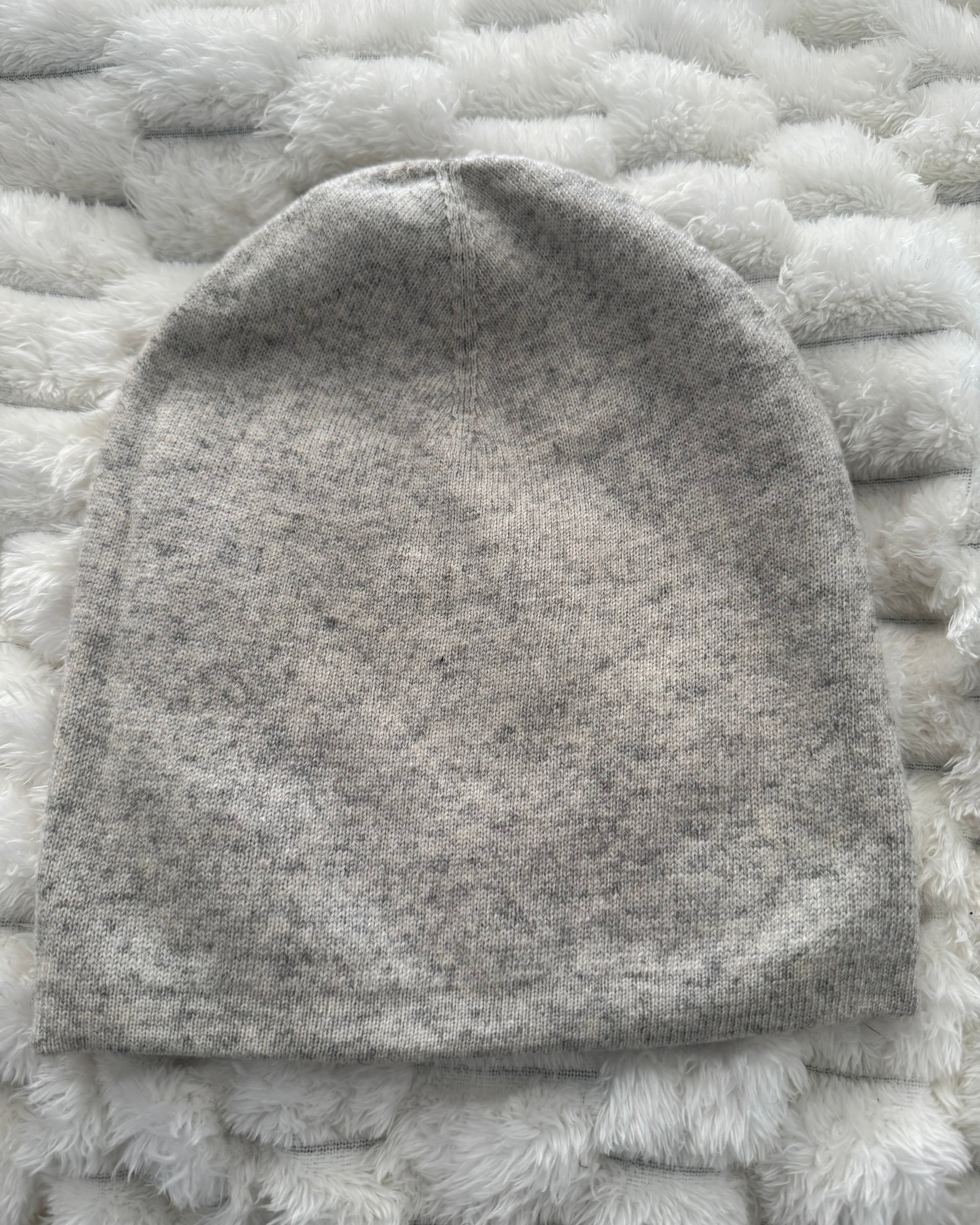 Gray beanie on a textured white surface