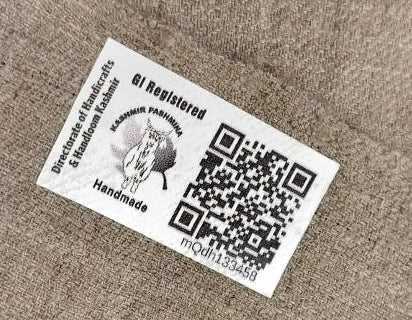 White card with black text and QR code on a brown textured background