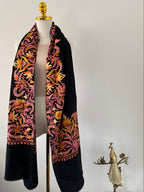 Decorative shawl with floral patterns on a white surface