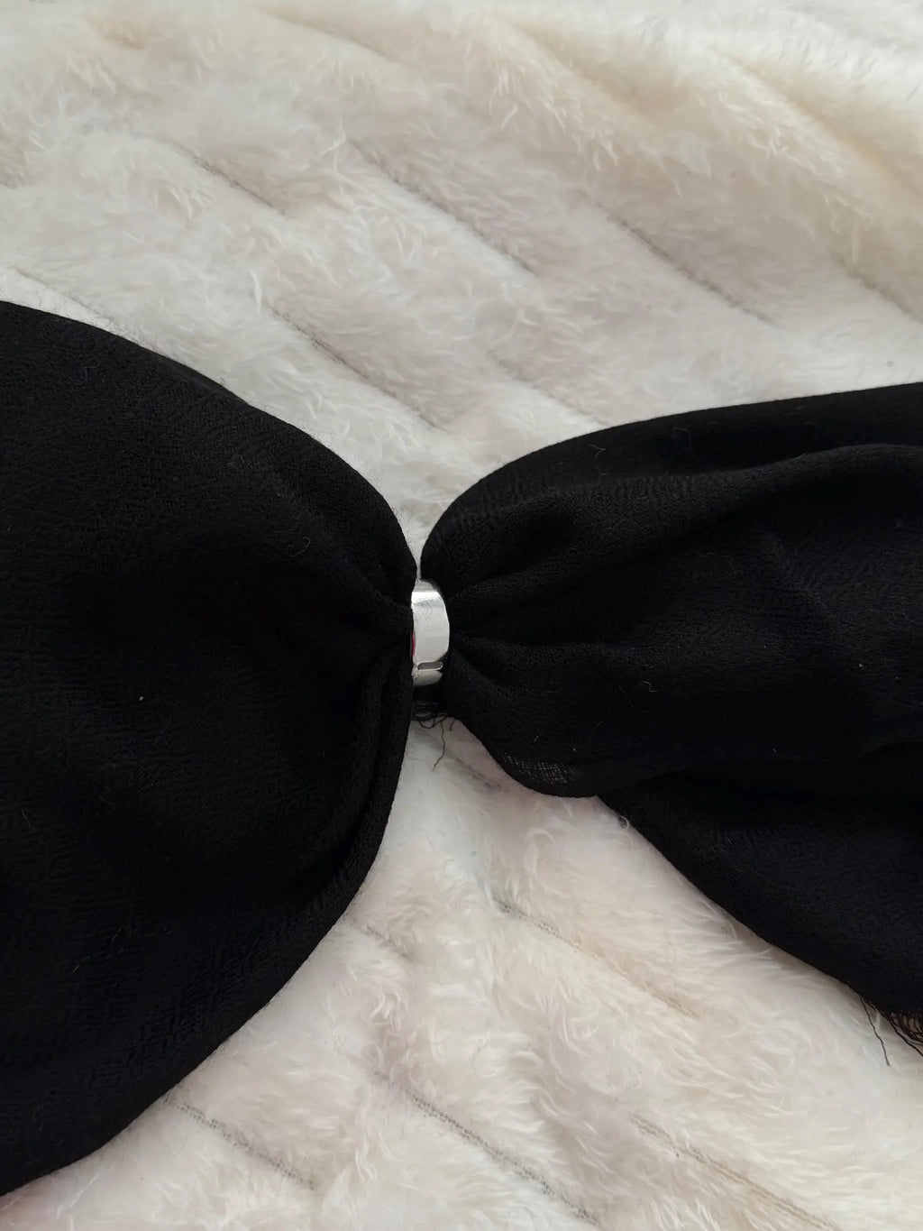 Black strapless top on a fur surface