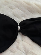 Black strapless top on a fur surface