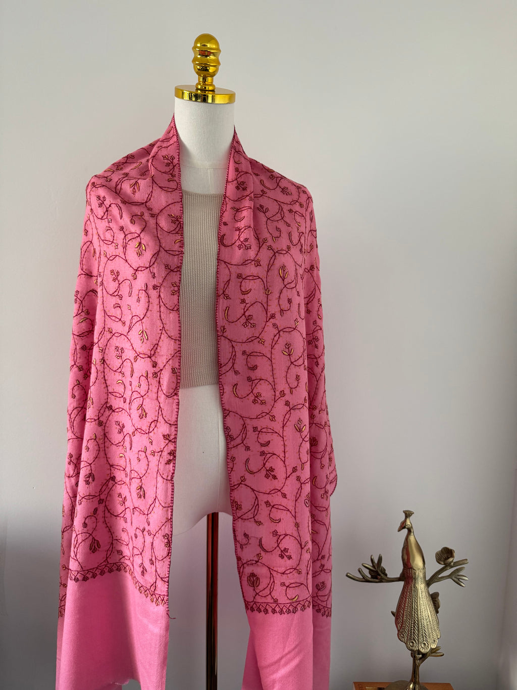 Pink fabric with a floral pattern on a white background