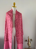 Pink fabric with a floral pattern on a white background