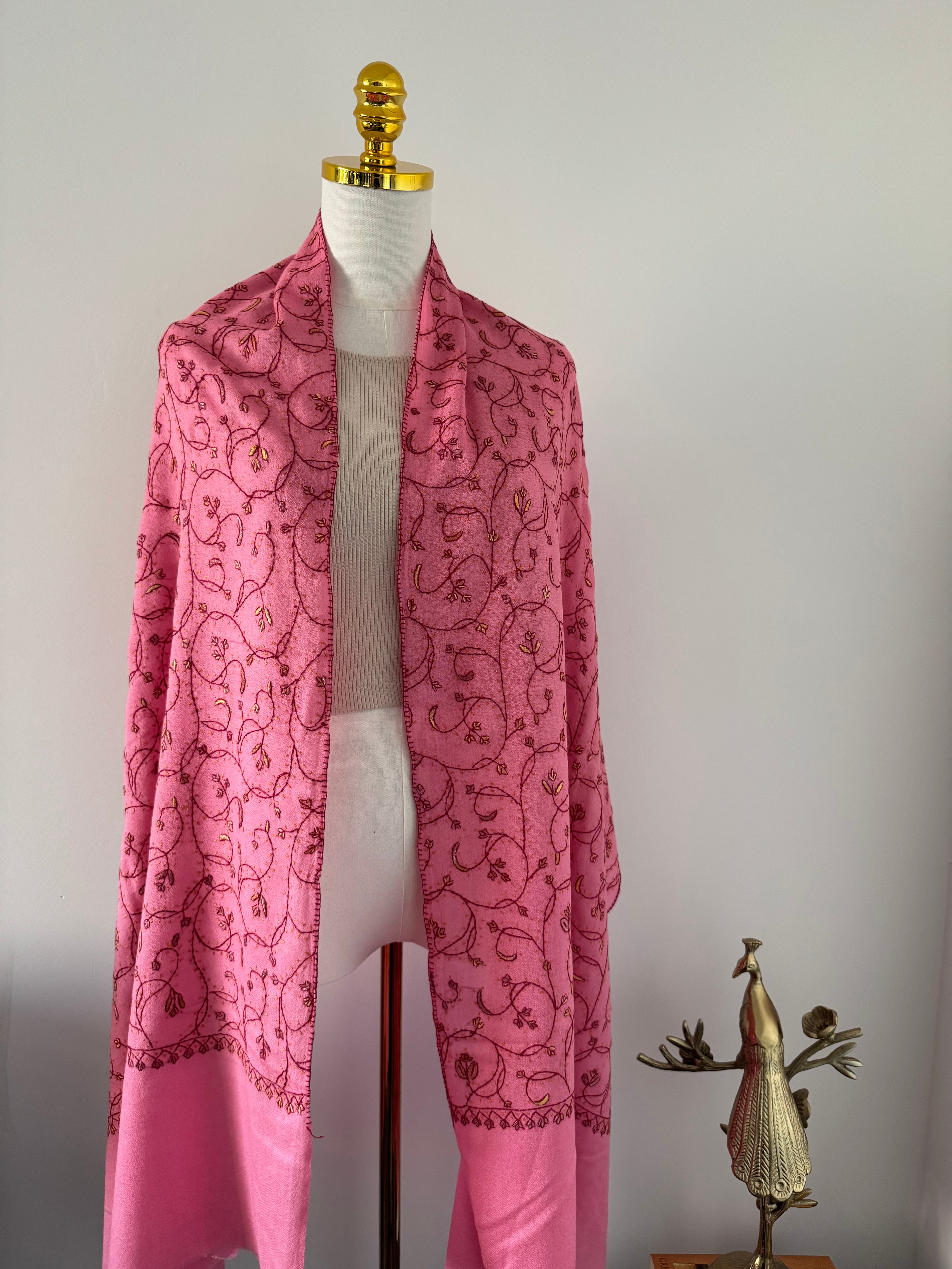 Pink fabric with a floral pattern on a white background