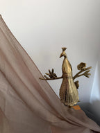 Gold peacock decorative item on a white background