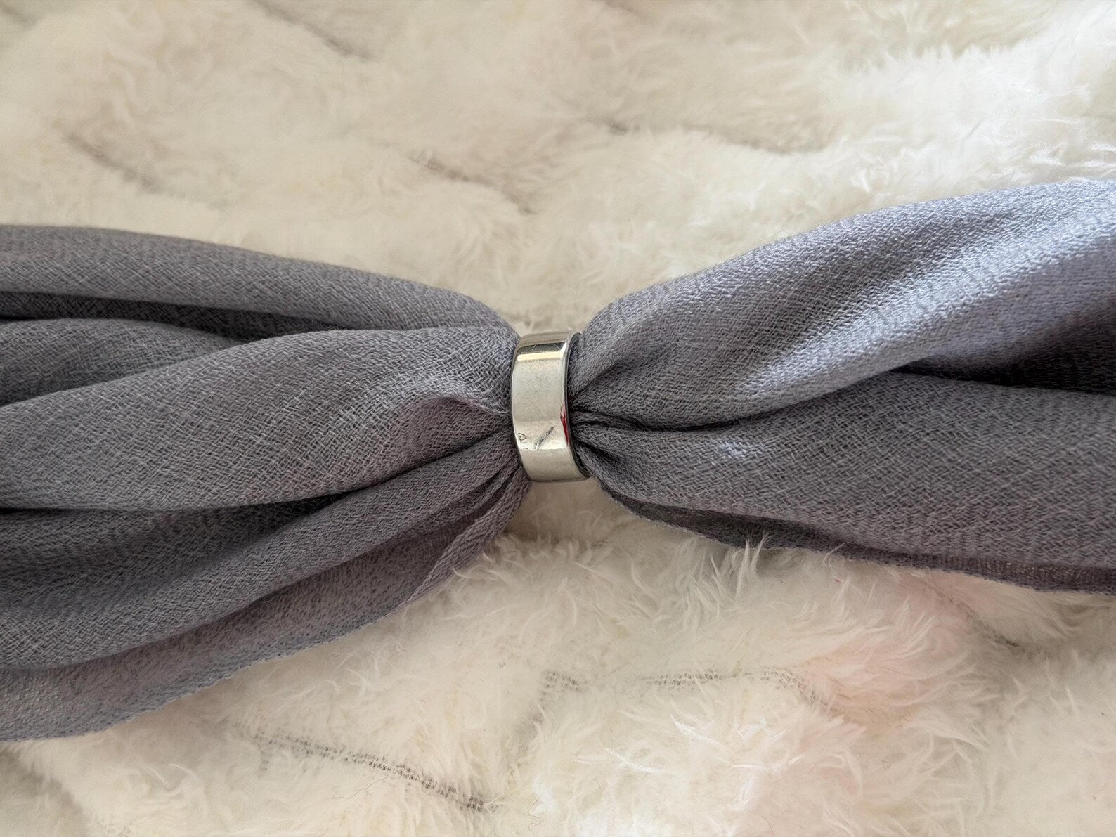 Gray with a metal clip on a beige background