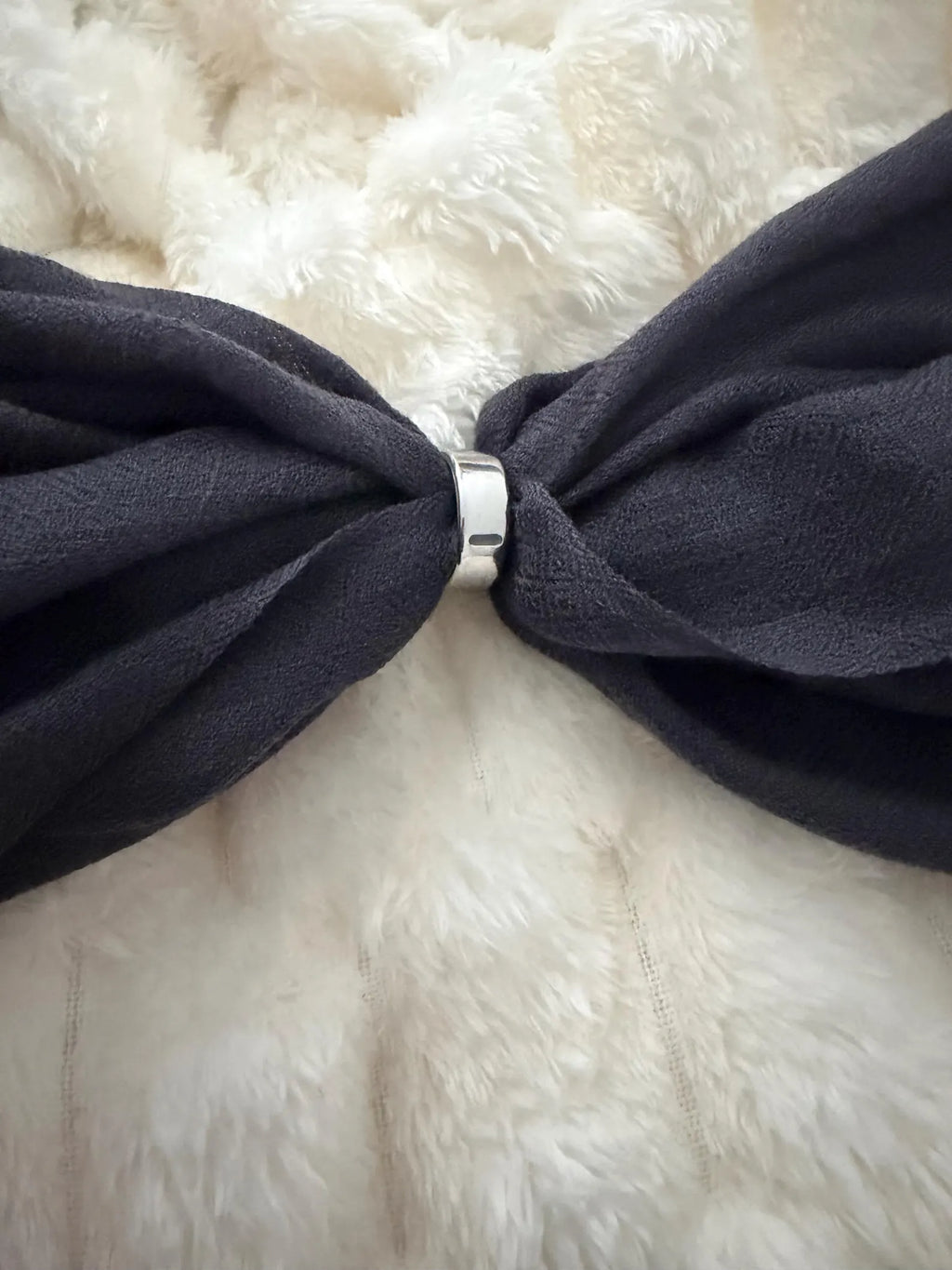 gray bow tie on a white fur background