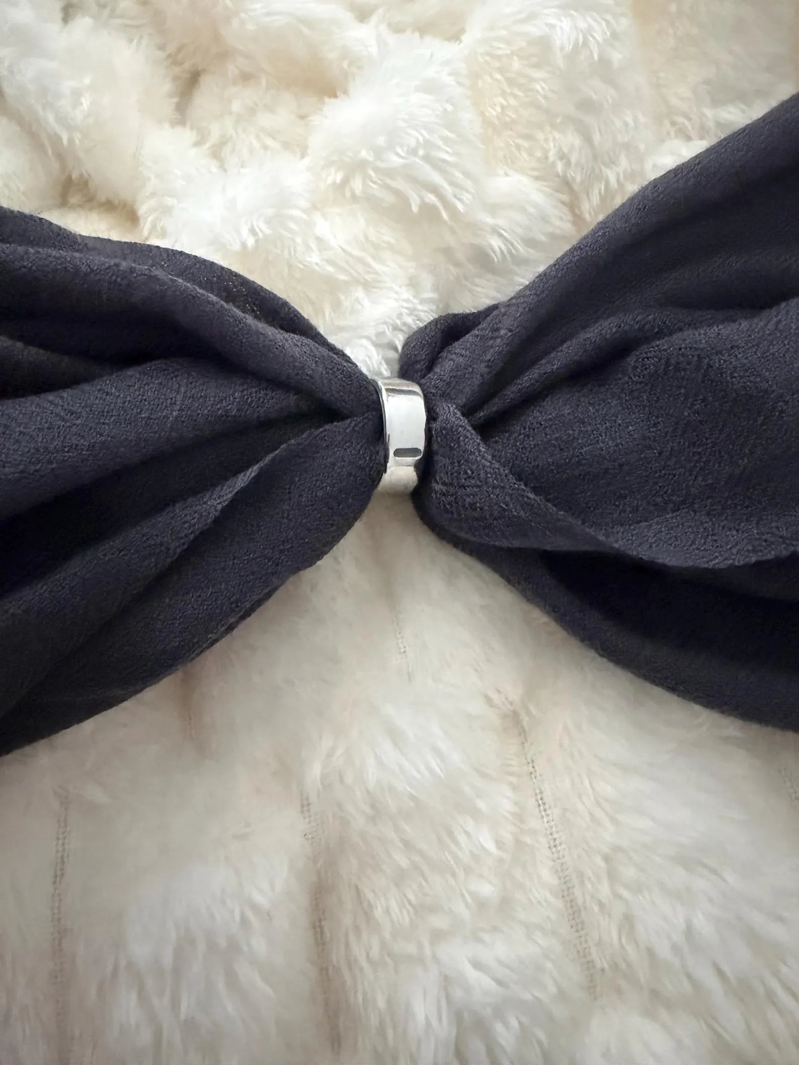 gray bow tie on a white fur background