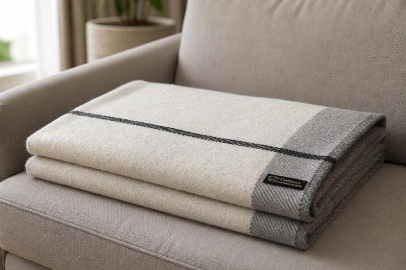 Folded ivory and grey cashmere throw blanket