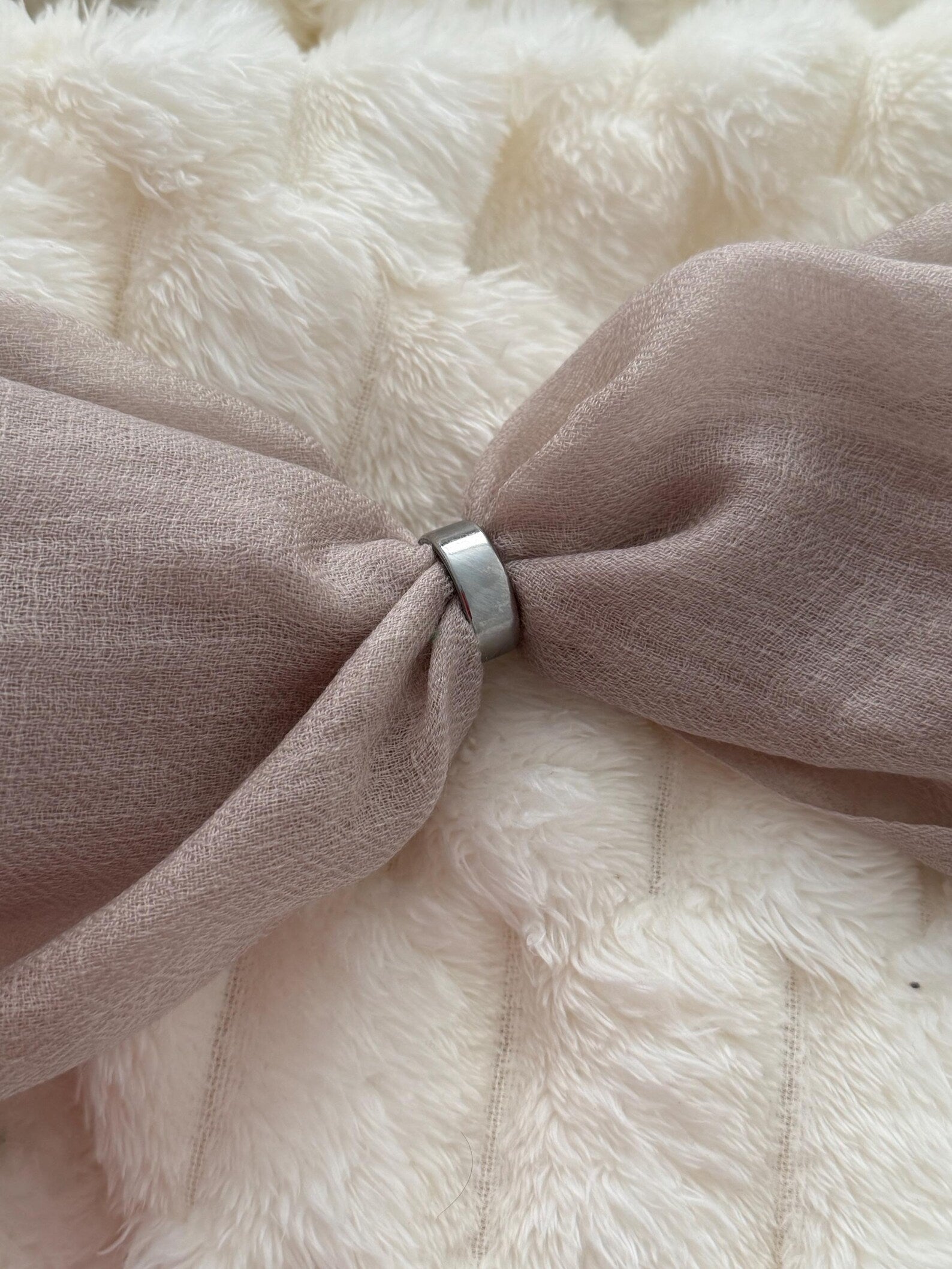 Close-up of a pink bow tie on a fluffy white background