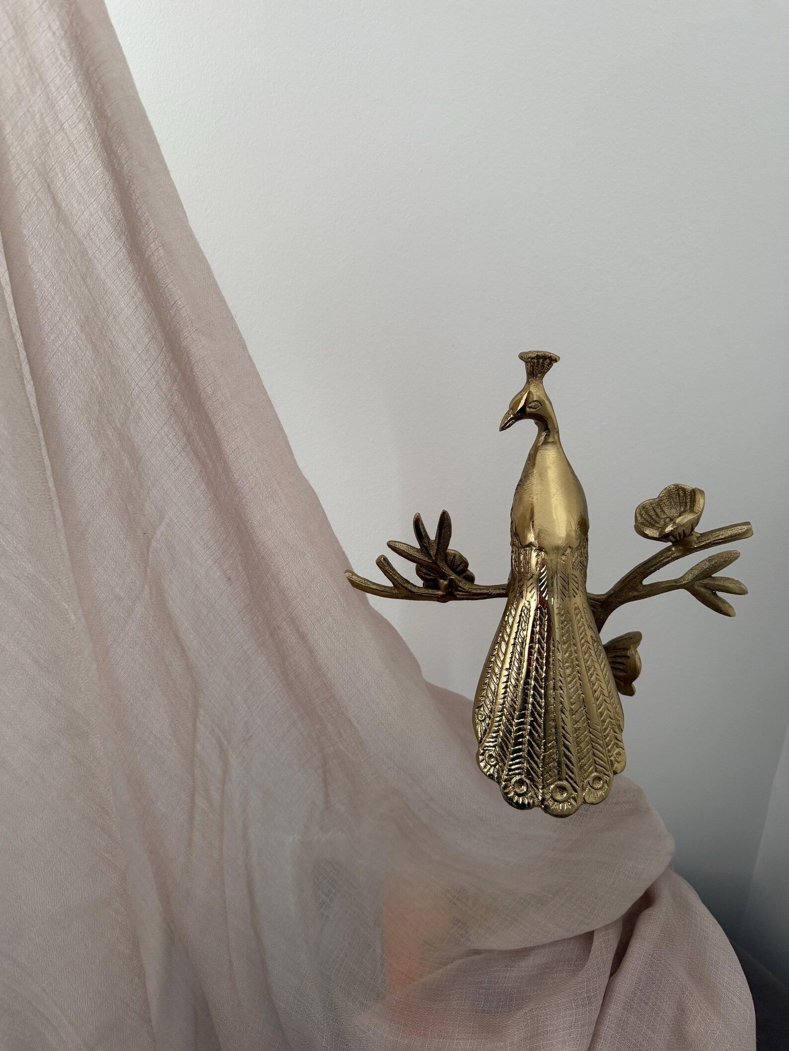 Bronze peacock figurine on a white background
