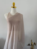 Mannequin wearing a beige sleeveless dress against a plain background