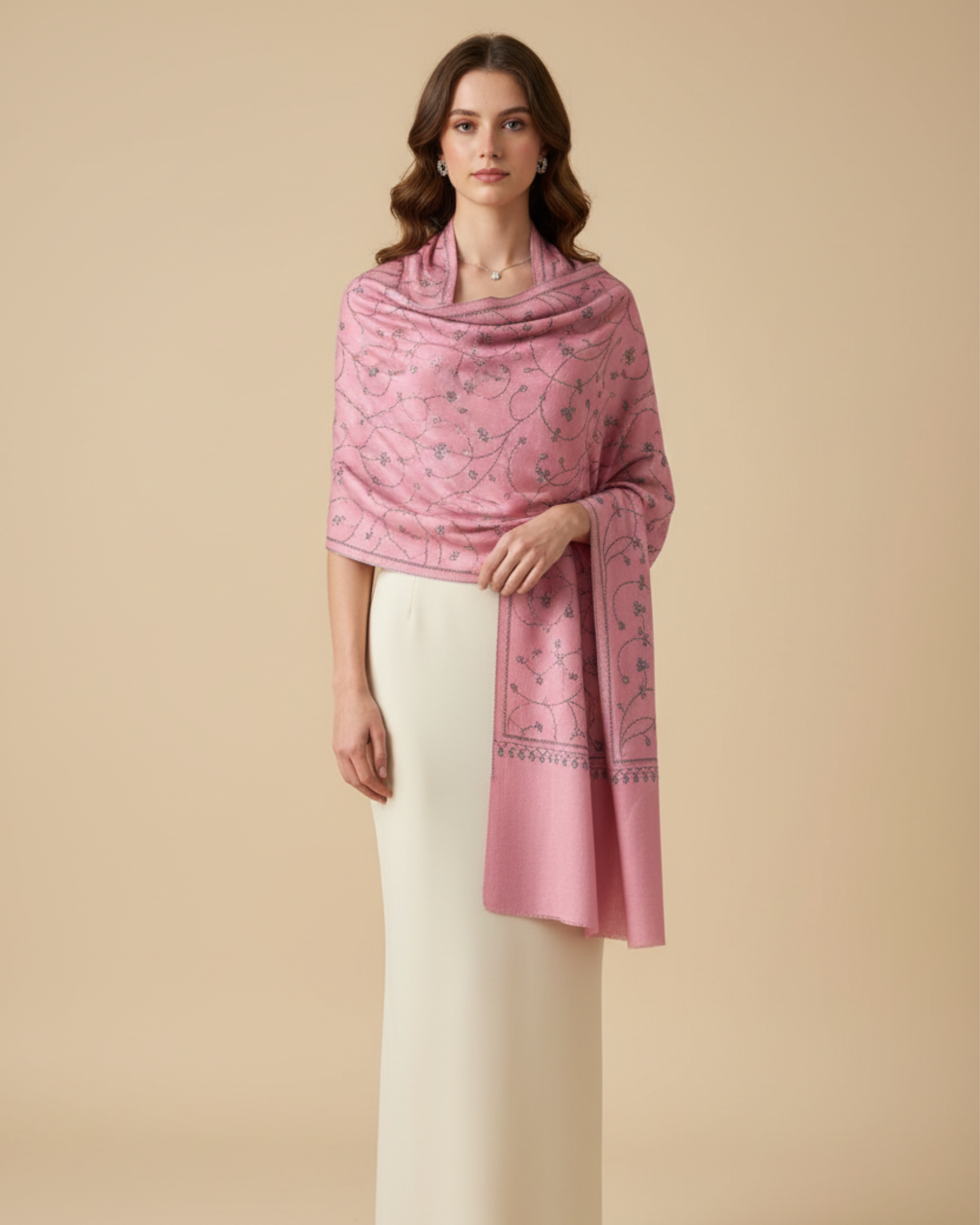 Woman wearing a pink shawl over a white outfit on a beige background