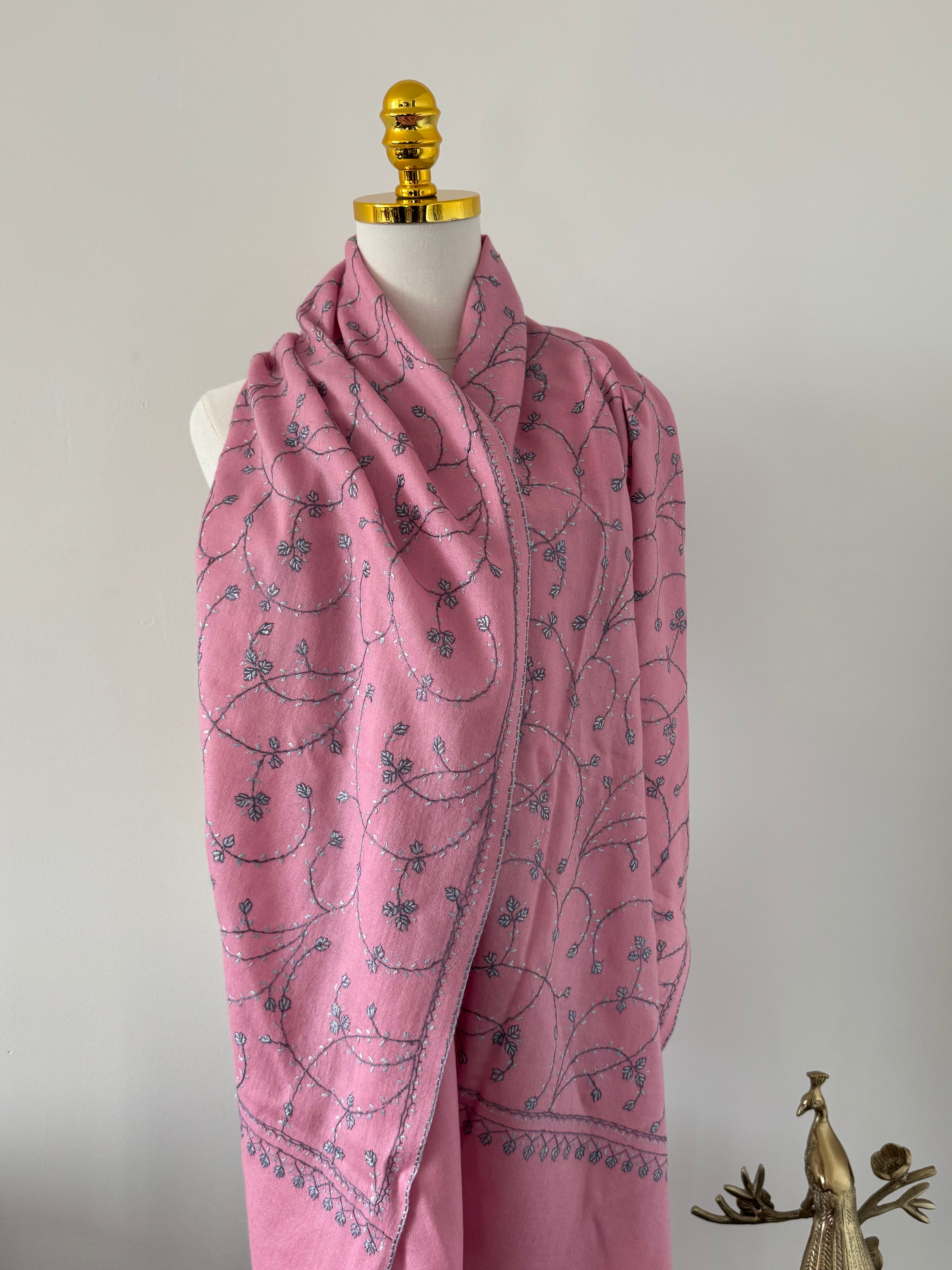 Pink fabric with blue patterns on a white background