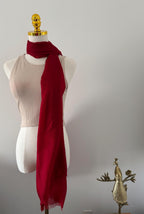 Red scarf on a mannequin with a plain background