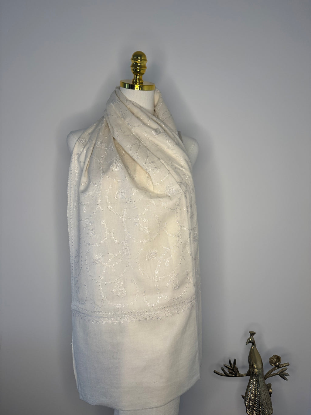 White fabric with a decorative embroidery on a plain background