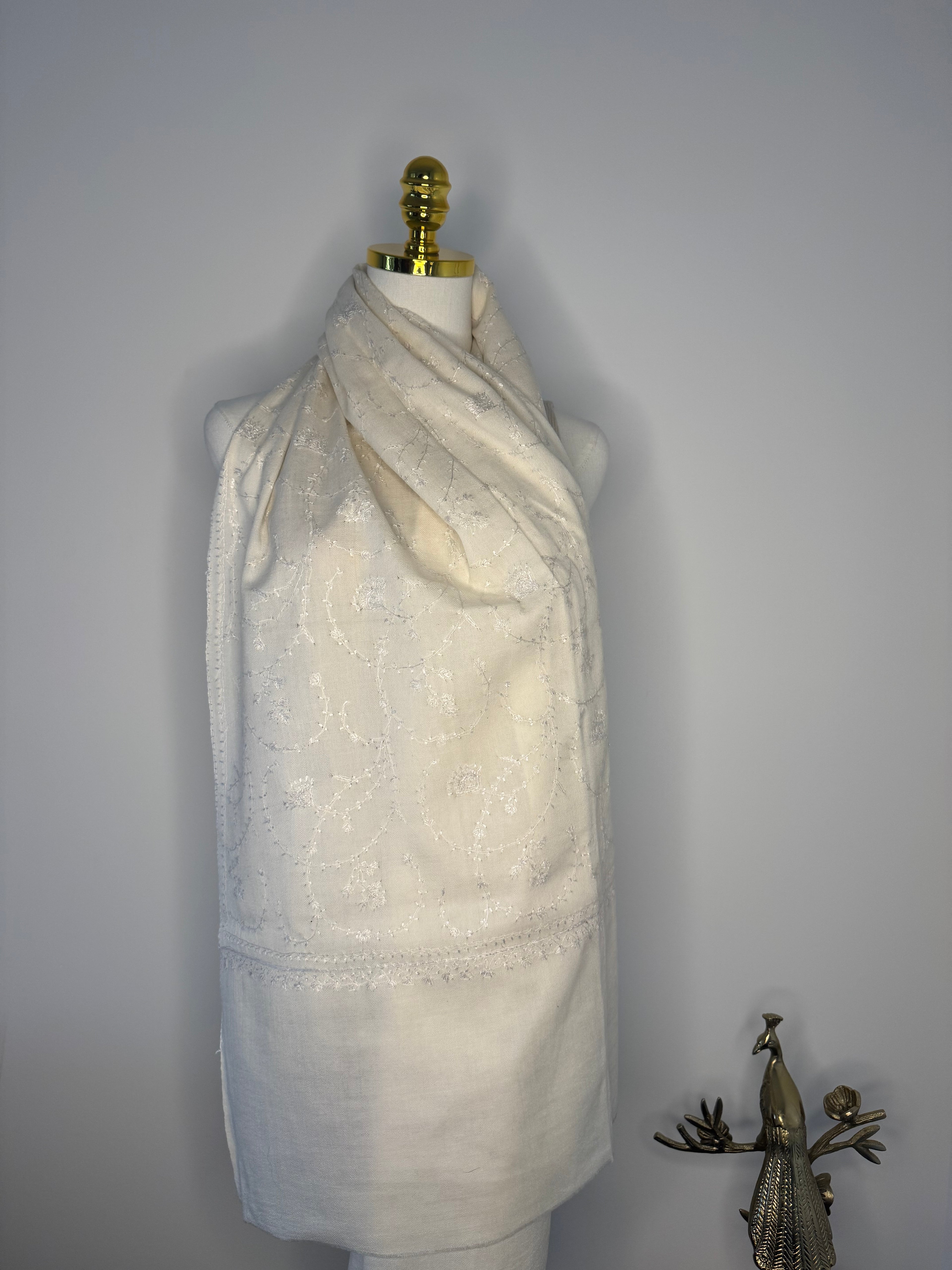 White fabric with a decorative embroidery on a plain background